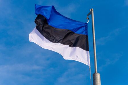 Estonian flag waving against blue sky in Boulogne sur Mer, France.の写真素材