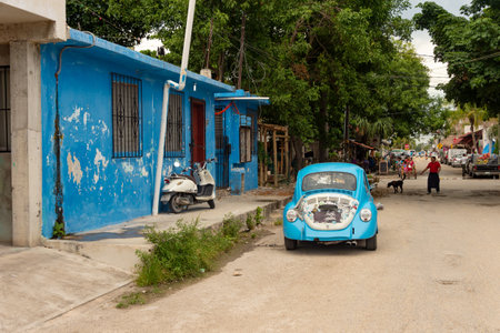 Tulum, Mexico - 7 August 2018: Blue Volkswagen Beetle parked in front of a blue house.のeditorial素材