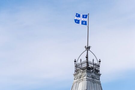 Quebec Flag at the top of the Quebec Parliament building in Quebec City.の写真素材