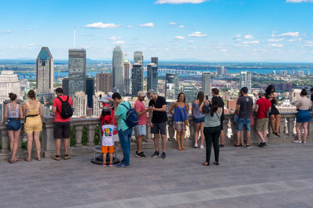 Montreal, CA - 7 July 2018: Tourists enjoying view of Montreal skyline from Kondiaronk Belvedere located at the top of the Mont-Royal mountain.のeditorial素材