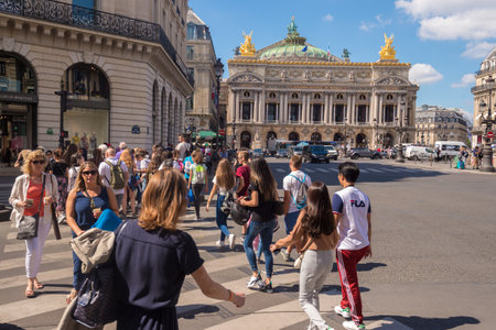 Paris, France - 25 June 2018: A crowd of people crossing Rue de la Paix near Paris Opera Garnier.のeditorial素材