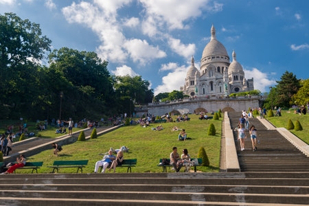 Paris, France - 25 June 2018: People relaxing on the grass in front of Basilica Sacre Coeur in Montmartreのeditorial素材