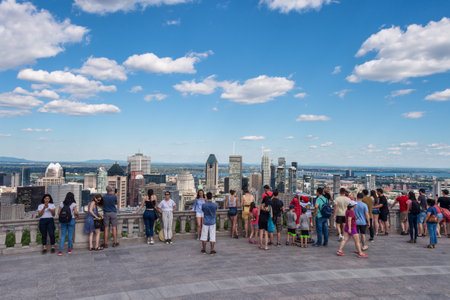 Montreal, CA - 7 July 2018: Tourists enjoying view of Montreal skyline from Kondiaronk Belvedere located at the top of the Mont-Royal mountain.のeditorial素材