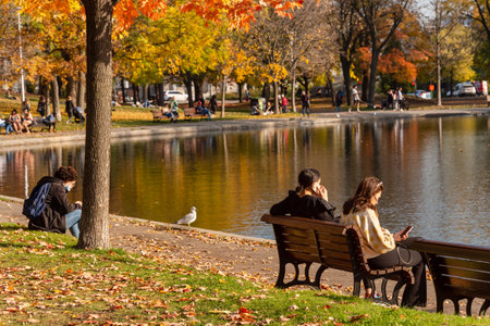 Montreal, CA - 23 October 2020: People enjoying a warm and sunny day at La Fontaine Park in the Autumn seasonのeditorial素材