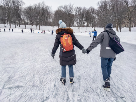 Montreal, Canada - 18 February 2021: People skating at Lafontaine Park natural ice rinkのeditorial素材