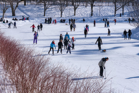 Montreal, Canada - 31 January 2021: People skating at Lafontaine Park natural ice rink