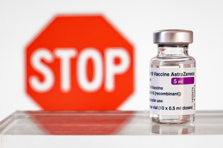 Montreal, CA - 15 March 2021: Vial of Astrazeneca Covid-19 vaccine in front of a stop signのeditorial素材