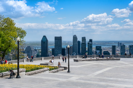 Montreal, CA - 14 May 2021: People enjoying view of Montreal skyline from Kondiaronk Belvedere located at the top of the Mont-Royal mountain.のeditorial素材