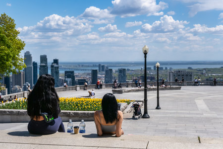 Montreal, CA - 14 May 2021: People enjoying view of Montreal skyline from Kondiaronk Belvedere located at the top of the Mont-Royal mountain.のeditorial素材