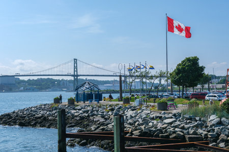 Halifax, Canada - 10 August 2021: Canadian Flag and Macdonald Bridgeのeditorial素材