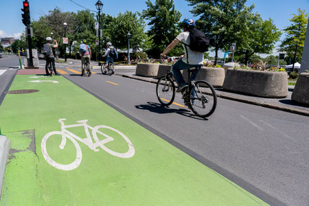 Montreal, Canada - 11 June 2022: People riding bikes on bike path in Old Montreal