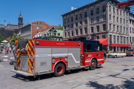 Montreal, CA - 11 June 2022: Red firetruck driving on De la Commune street in Old Montrealのeditorial素材