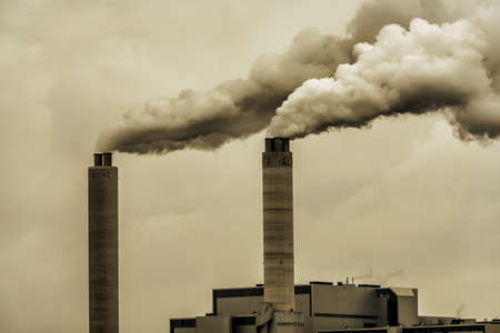 Chimneys and dark smoke coming out of a factory