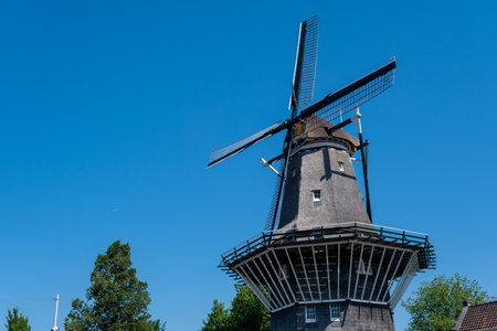 Amsterdam, The Netherlands - 23 June 2022: De Gooyer Windmill over blue sky