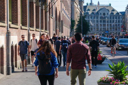 Amsterdam, The Netherlands - 22 June 2022: People walking on narrow street with many storesのeditorial素材
