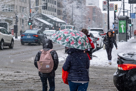 Montreal, CA - 16 November 2022: First snowfall of the season hits the city. People walking in Montreal Downtownのeditorial素材
