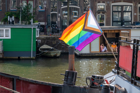 Amsterdam, Netherlands - 6 September 2022: Gay rainbow flag on a barge boat at the waterfrontのeditorial素材