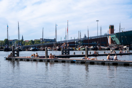 Amsterdam, The Netherlands - 6 September 2022: People bathing at the Marineterrein's inner harbourのeditorial素材