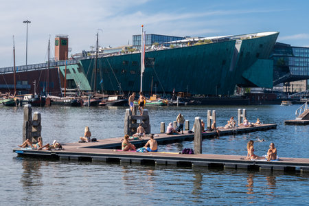Amsterdam, The Netherlands - 6 September 2022: People bathing at the Marineterrein's inner harbourのeditorial素材