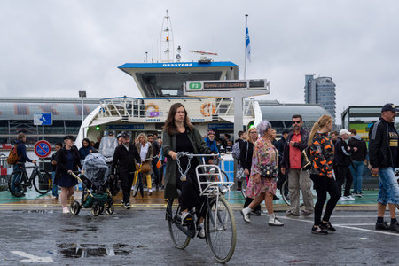 Amsterdam, The Netherlands - 8 September 2022: People leaving a GVB ferryboatのeditorial素材