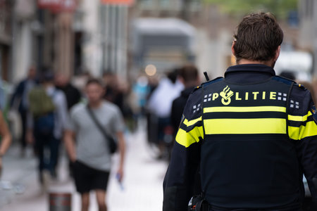 Amsterdam, The Netherlands - 8 September 2022: Backview of a dutch policeman on the streetのeditorial素材