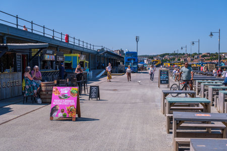 Folkestone, UK - 9 July 2023: Outdoor dining terrace, Folkestone Harbour Arm, Kentのeditorial素材