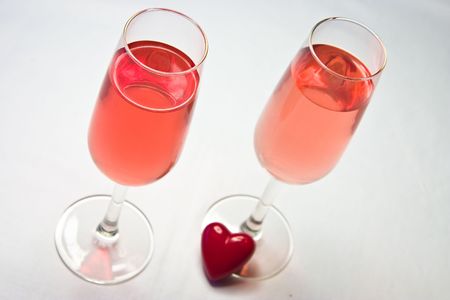 pink wine in stylish glasses with a red heartの写真素材