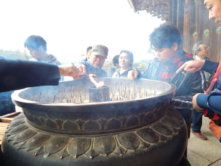 People pray with incense in the temple.の写真素材
