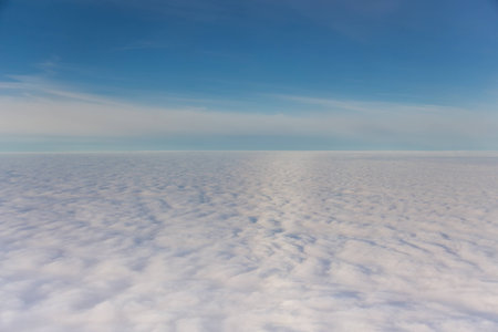 white fluffy clouds to the horizon and the blue skyの写真素材