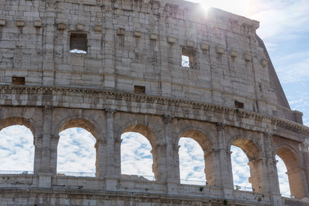 detail view of beautiful architecture of historic colosseum in rome italy on sunny day and clouds greenの写真素材