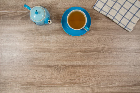 pot and cup of tea on wooden tableの写真素材