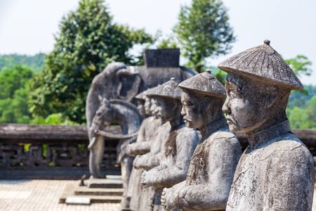 ancient stone statues of asian soldiers with weapons and in full armor in Vietnamの写真素材
