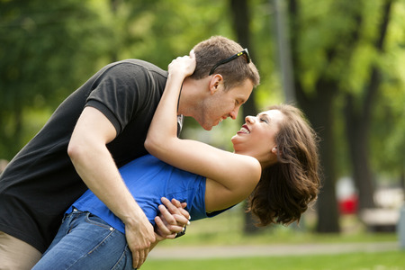 Young couple in love outdoorin lovekissing and embracingの写真素材