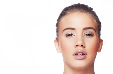 Beautiful young blond woman with ponytail and pink lipsの写真素材