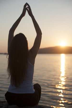 Relaxation on the water outdoors, woman with hands upの写真素材