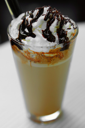 Ice coffee in glass with ice cream and cream chocolate and strawの写真素材