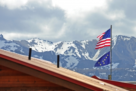 American and Alaskan Flag with the mountains of Denali National Park in Alaskaの写真素材