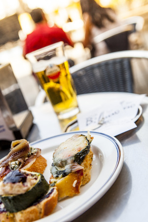 A plate of tapas on a Bilbao terrasの写真素材