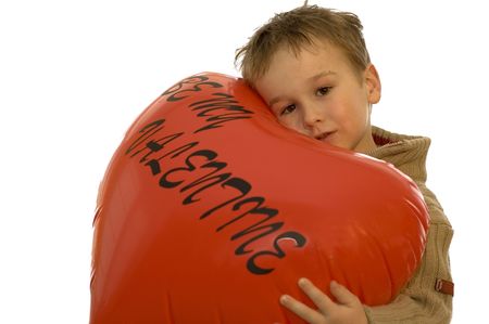 little 5-year old holding a valentine heart.の写真素材