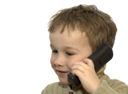 a 5-year old calling his grandma. he is listening very careful. on white background.の写真素材
