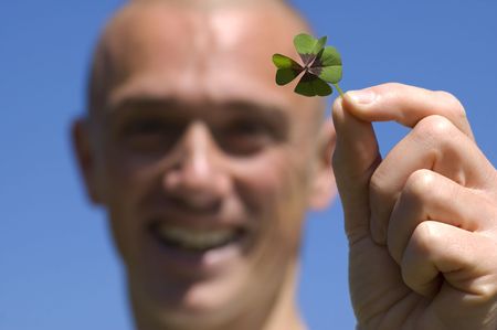 This man found a four leaf clover, it's his lucky day!の写真素材
