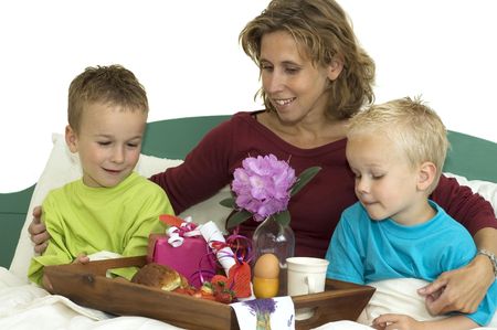 Nice family having a breakfast in bed. It is Mothers Day.の写真素材
