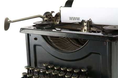An old ancient typewriter is used to type an internet address. Isolated on white.の写真素材