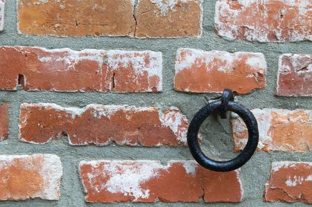 Texture of and old wall with colored bricks and ringの写真素材