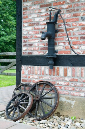 Picture of old farm equipment, against the farmの写真素材