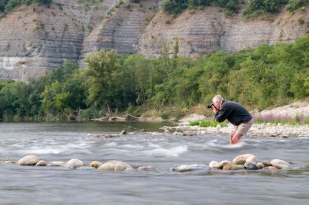 Photographer risking his camera in the stream of the Ardeche, Franceの写真素材
