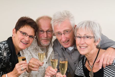 Two senior couples toasting on a Happy New Year.の写真素材