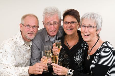 Two senior couples toasting on a Happy New Year.の写真素材