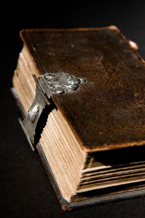 Nice old bible with an old lock on a black background.の写真素材
