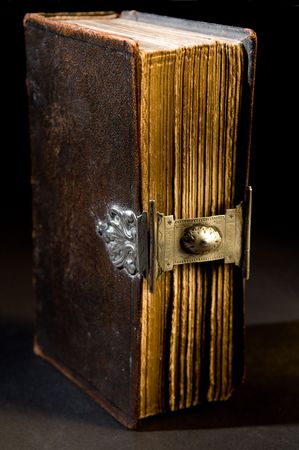 Nice old bible with an old lock on a black background.の写真素材